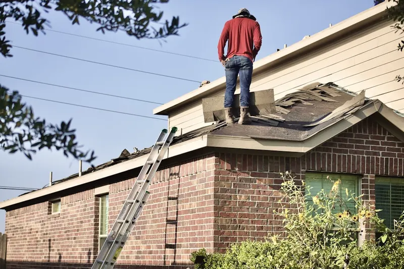 Professional roofer working on a residential roof in Sandpoint